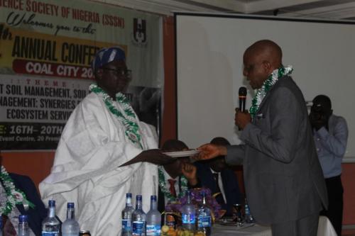 Prof.-B.-A.-Raji-receiving-Kolanuts-from-the-Chairman-of-the-Opening-Ceremony-of-Coal-City-Conference